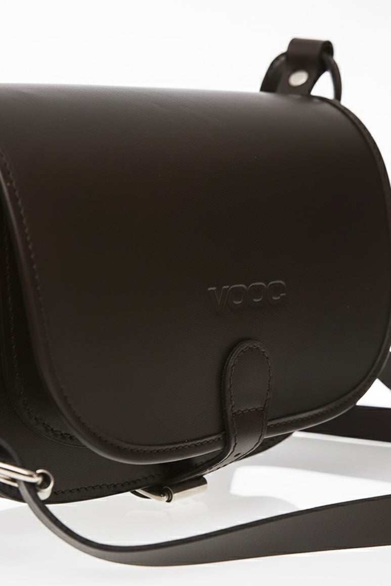 Black women's leather bag handcrafted from natural juchta leather with a sleek flap and adjustable strap