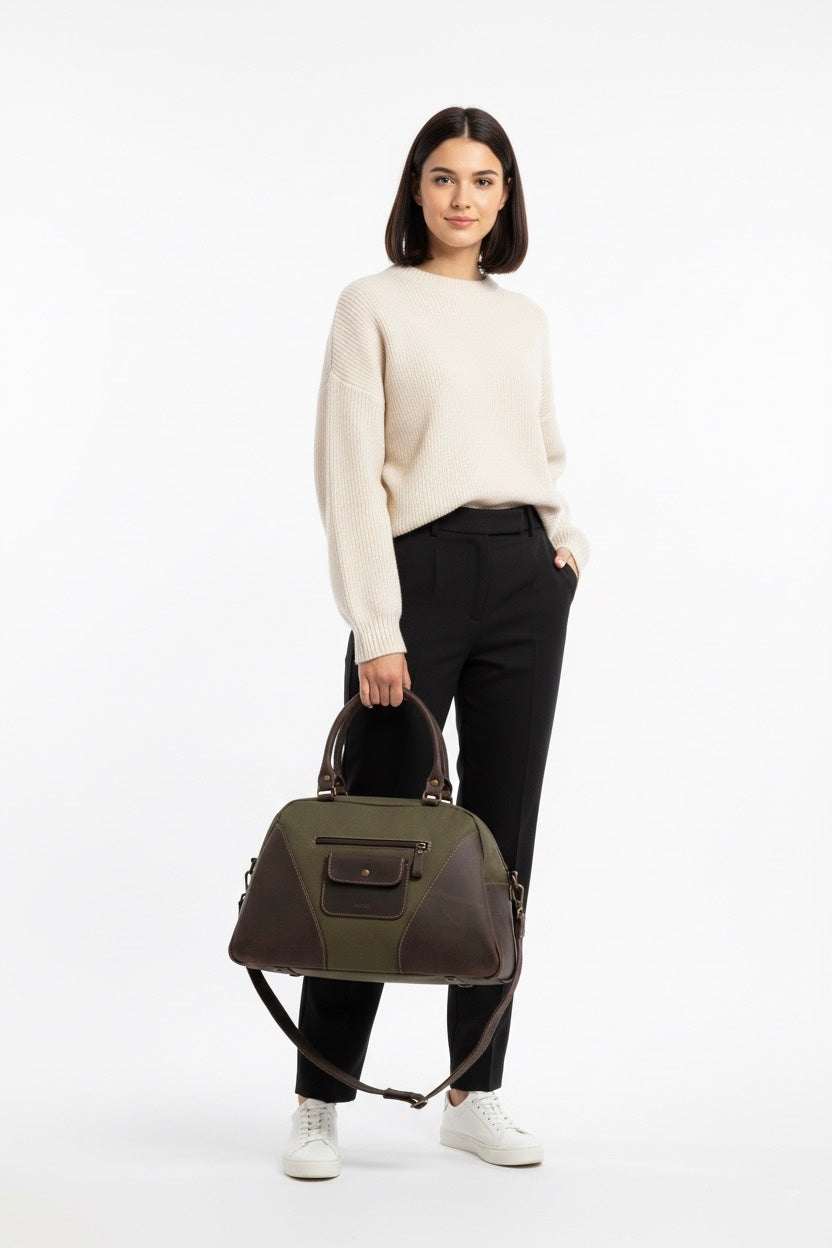 Woman holding VOOC Tiara EC7 canvas shoulder bag with leather accents in casual outfit