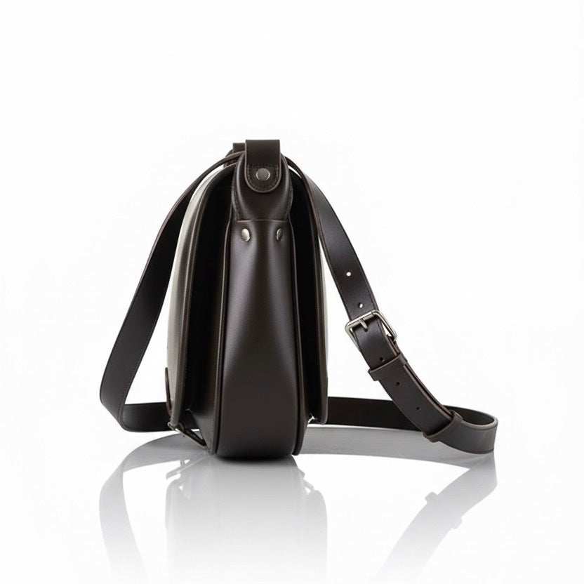 Side view of VOOC Vintage P27 Postbag in dark natural juchta leather with adjustable shoulder strap