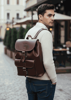 Man wearing large handmade leather backpack in vintage style walking outdoors