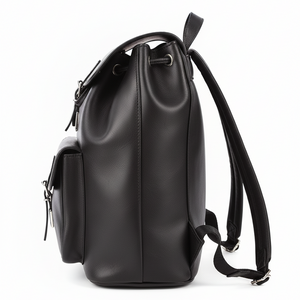 Side view of a large handmade natural black leather backpack with adjustable padded shoulder straps and front pocket.