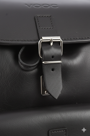 Close-up of a large handmade natural leather backpack buckle and front pocket detail