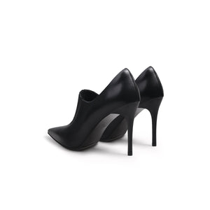 A black leather stiletto heel with a pointed toe and elastic upper detail, photographed on a white background.