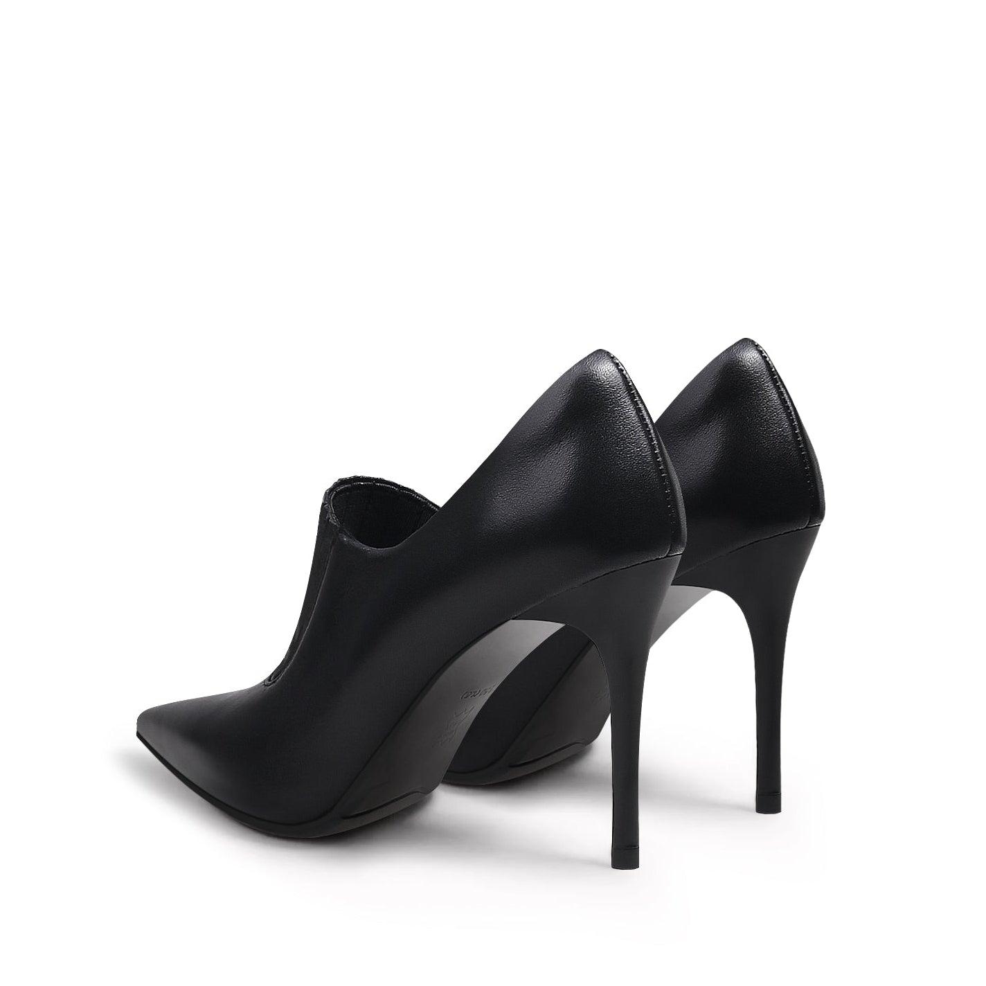 A black leather stiletto heel with a pointed toe and elastic upper detail, photographed on a white background.