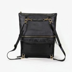 A black convertible eco-leather backpack purse with gold hardware and adjustable straps, photographed on a white background.