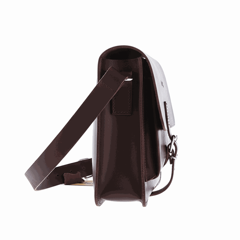 Side view of a vintage natural leather shoulder purse with adjustable strap and traditional buckle closure.