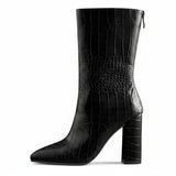 A black faux crocodile leather mid-calf boot with a pointed toe and block heel, photographed on a white background.