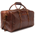 A 20-inch antique brown full-grain leather duffel bag with brass hardware, double handles, and detachable shoulder strap, photographed on a white background.