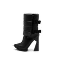 A black puffy vegan leather platform boot with adjustable straps and geometric high heel, photographed on a white background.