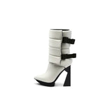 A black puffy vegan leather platform boot with adjustable straps and geometric high heel, photographed on a white background.